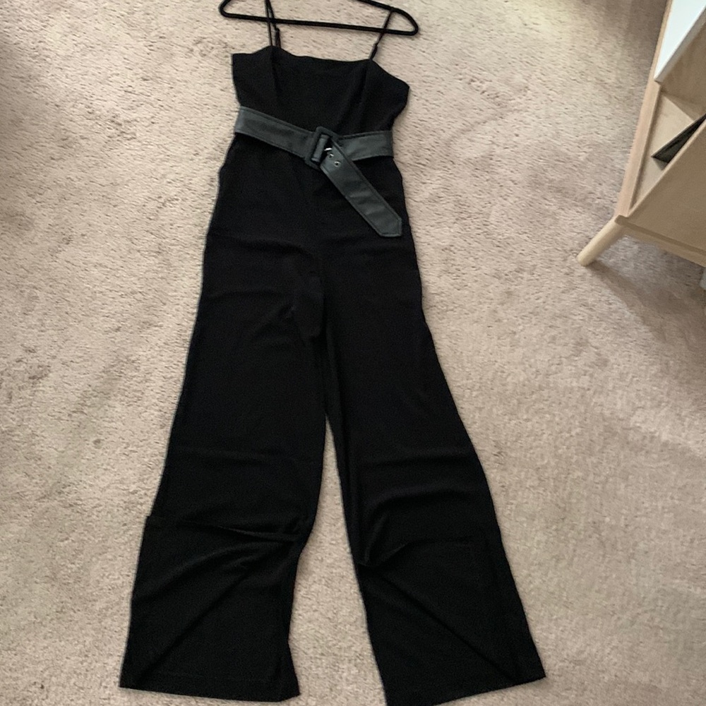 Sophisticated, belted jumpsuit with pockets and slits at the ankles.